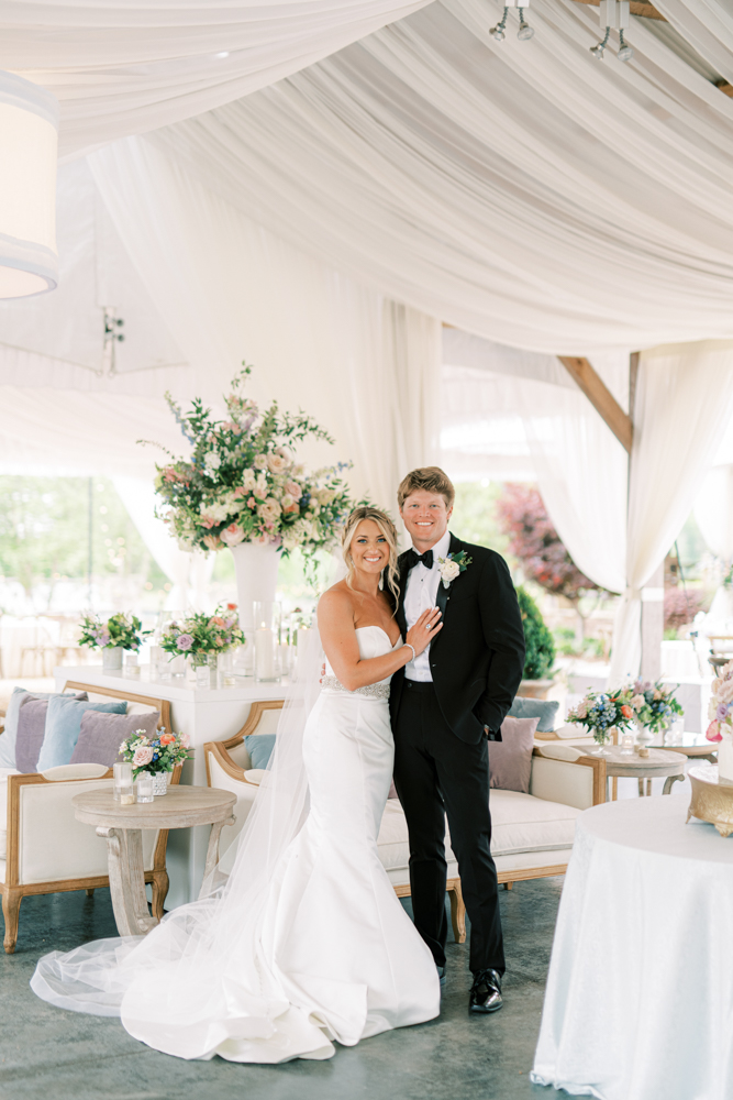 The couple enjoys their wedding reception tent at Otter Creek Farmstead in Alabama.