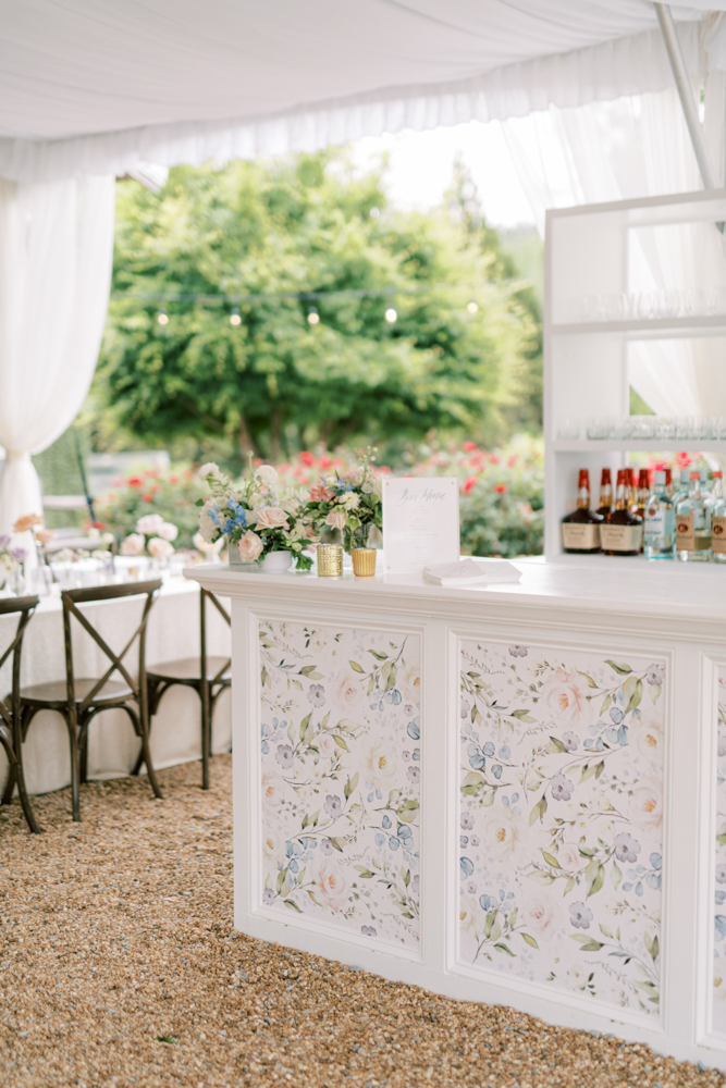 The wedding reception bar features custom panels of hand-painted florals in Alabama.