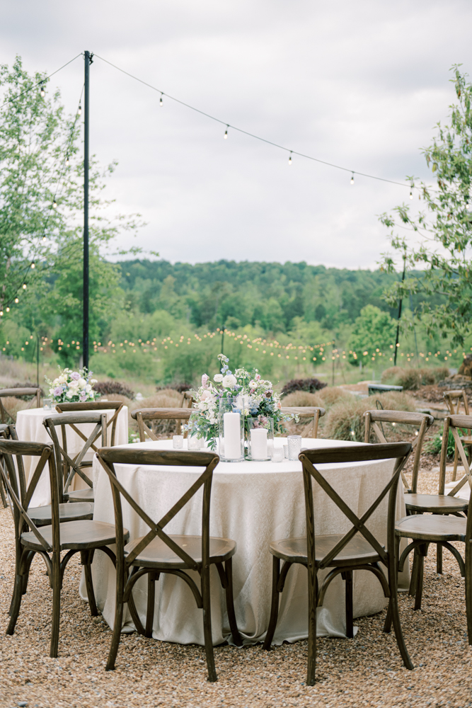 The wedding reception table is decorated with flowers and candles overlooking the view in Ohatchee, Alabama.