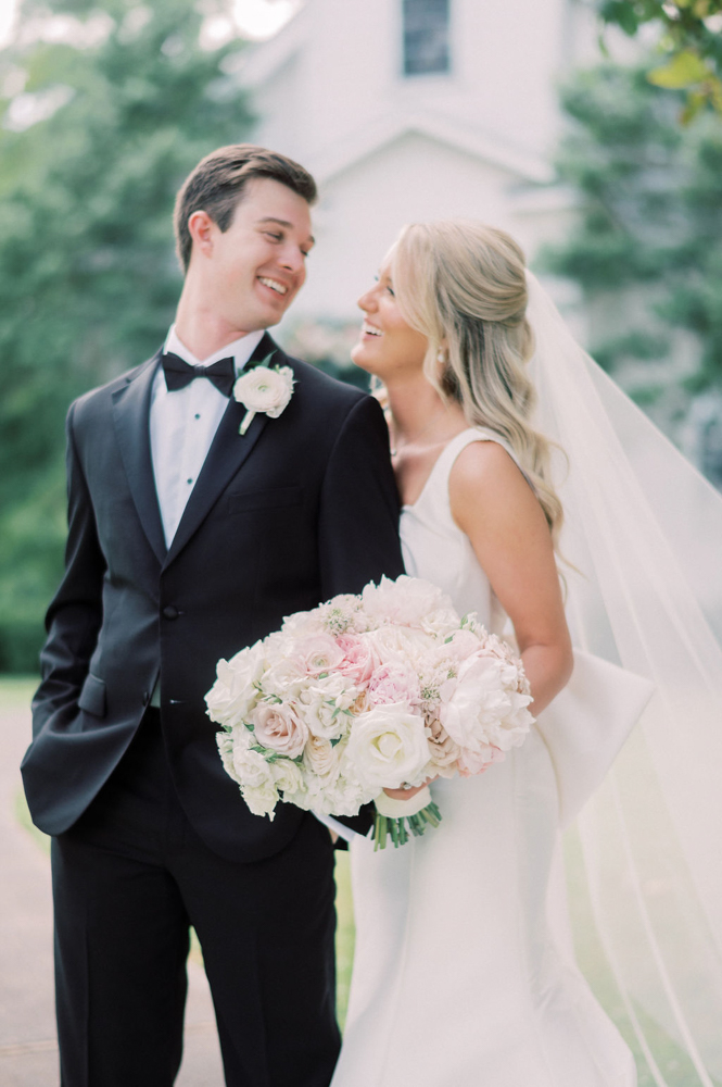 The bride and groom laugh together before the wedding ceremony at Children's Harbor in Alabama.