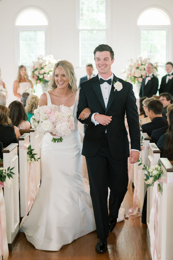 The bride and groom exit the wedding ceremony in Alabama.