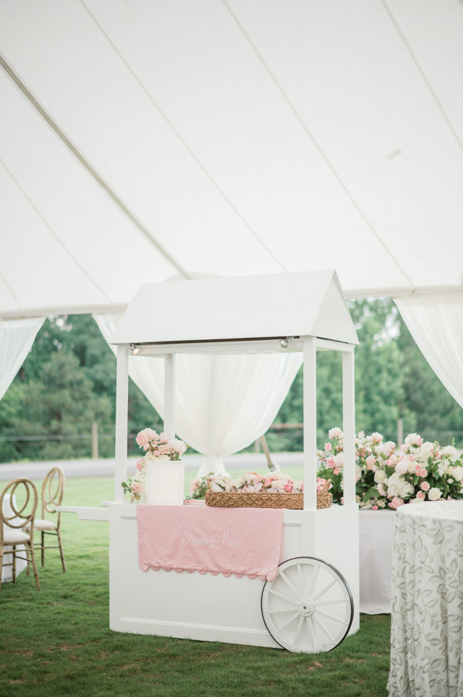 A flower bar by Prophouse awaits wedding guests in the reception tent in Alabama.