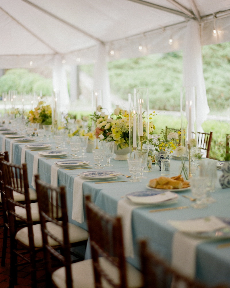 The reception table is decorated with wild flowers and candles at Windwood Equestrian.