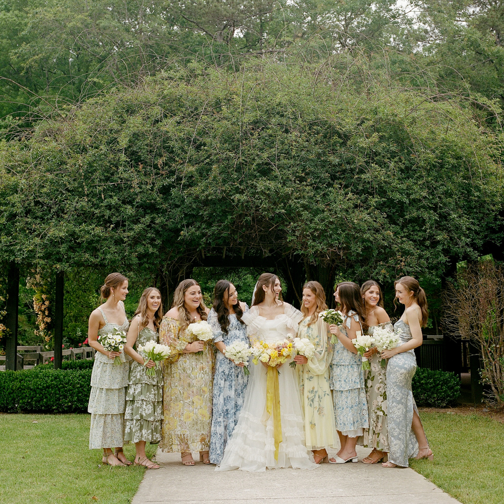 The bridesmaids wear different print dresses for this Southern wedding at Windwood Equestrian.