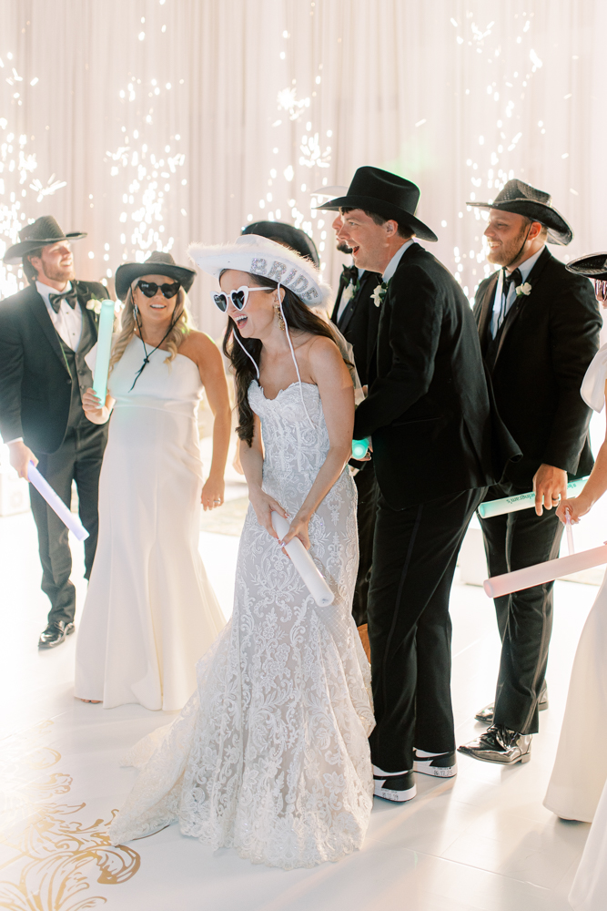 The bride and groom put on cowboy hats to celebrate the reception with cold sparks on the dance floor.