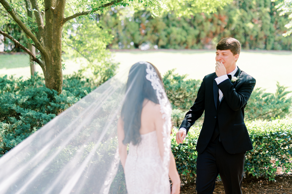 The groom sees his bride for the first time on the day of their Southern wedding.