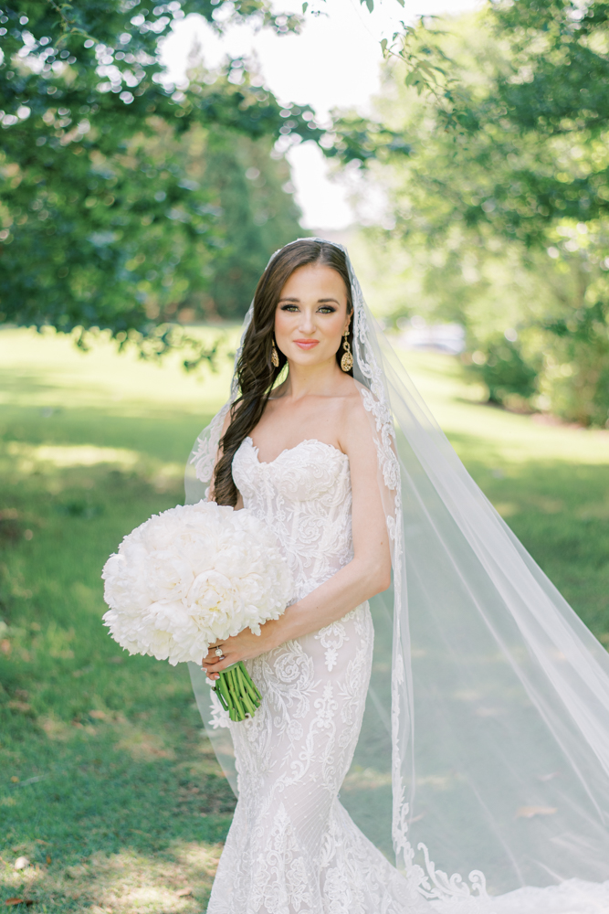 The bride holds a bouquet of white peony for her Southern wedding.