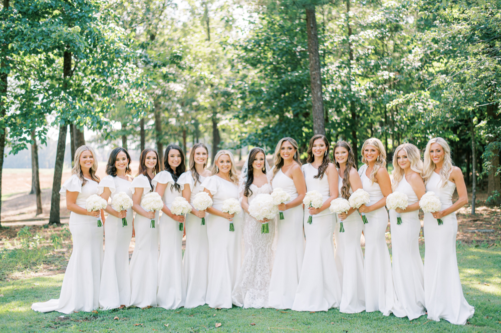 The bridesmaids all stand together on the grounds of Ross Bridge Resort in Alabama.