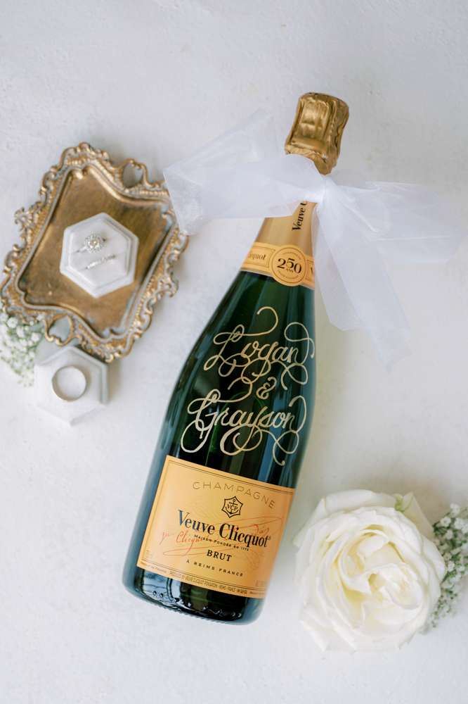 The engraved champagne bottle has the bride and groom's names on it.