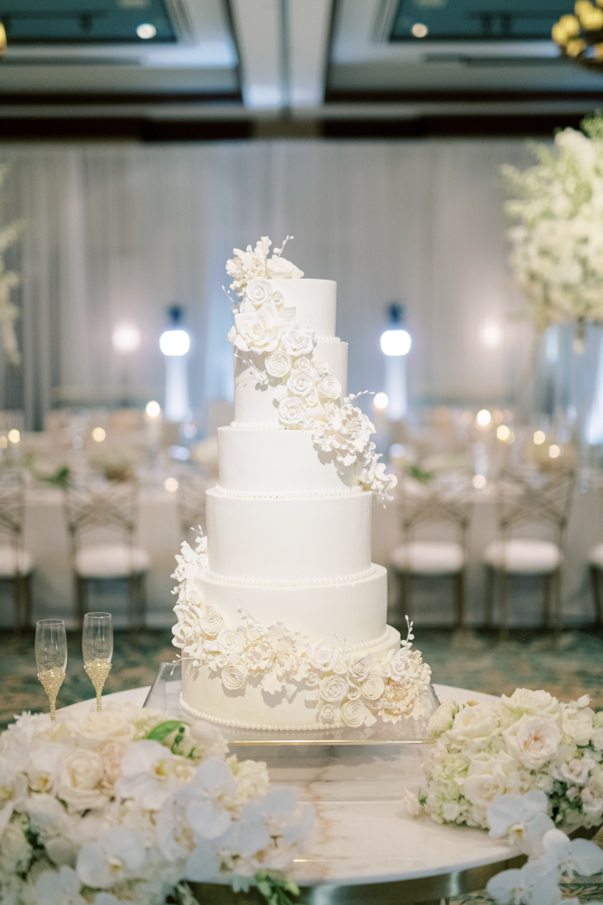 A classic white wedding cake is decorated with sugar flowers at Ross Bridge Resort.