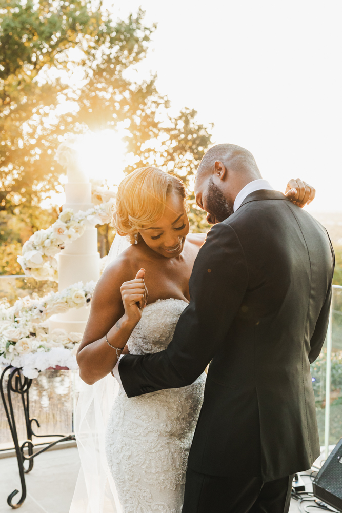 The bride and groom share a dance as the sun sets on their Birmingham wedding.