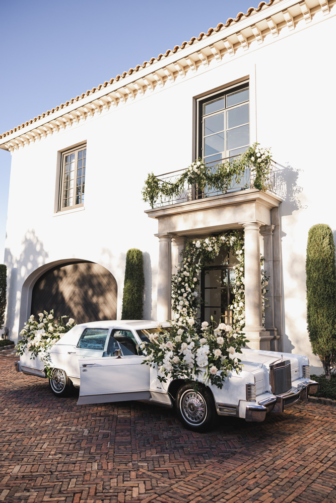 The vintage car is decorated with white flowers for the wedding day in Birmingham, Alabama.