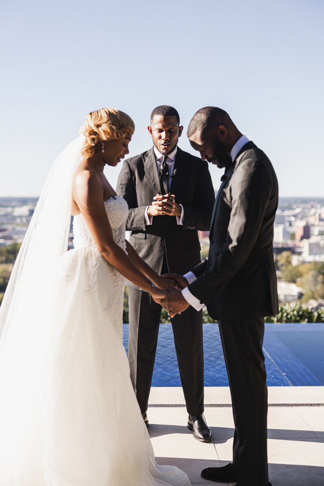 The bride and groom bow their heads together during the Birmingham wedding ceremony.