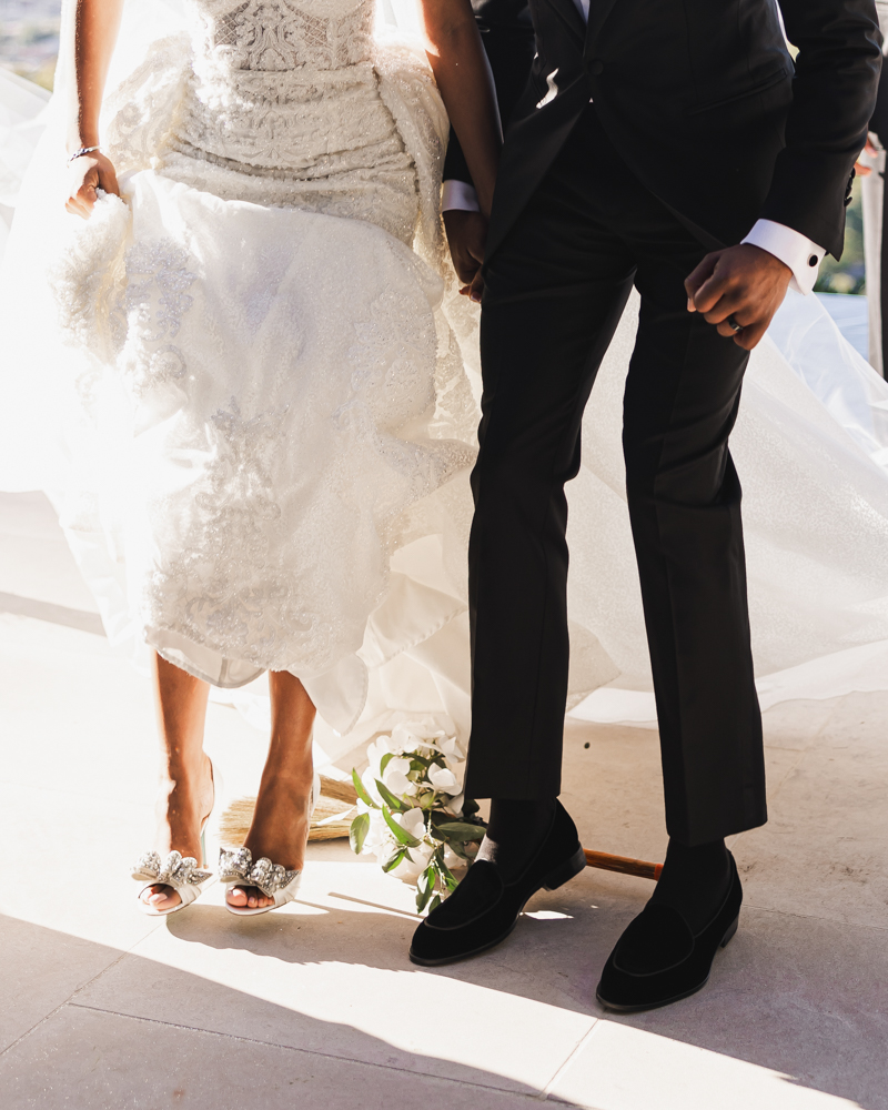 The bride and groom jump the broom together during the Birmingham, Alabama wedding ceremony.