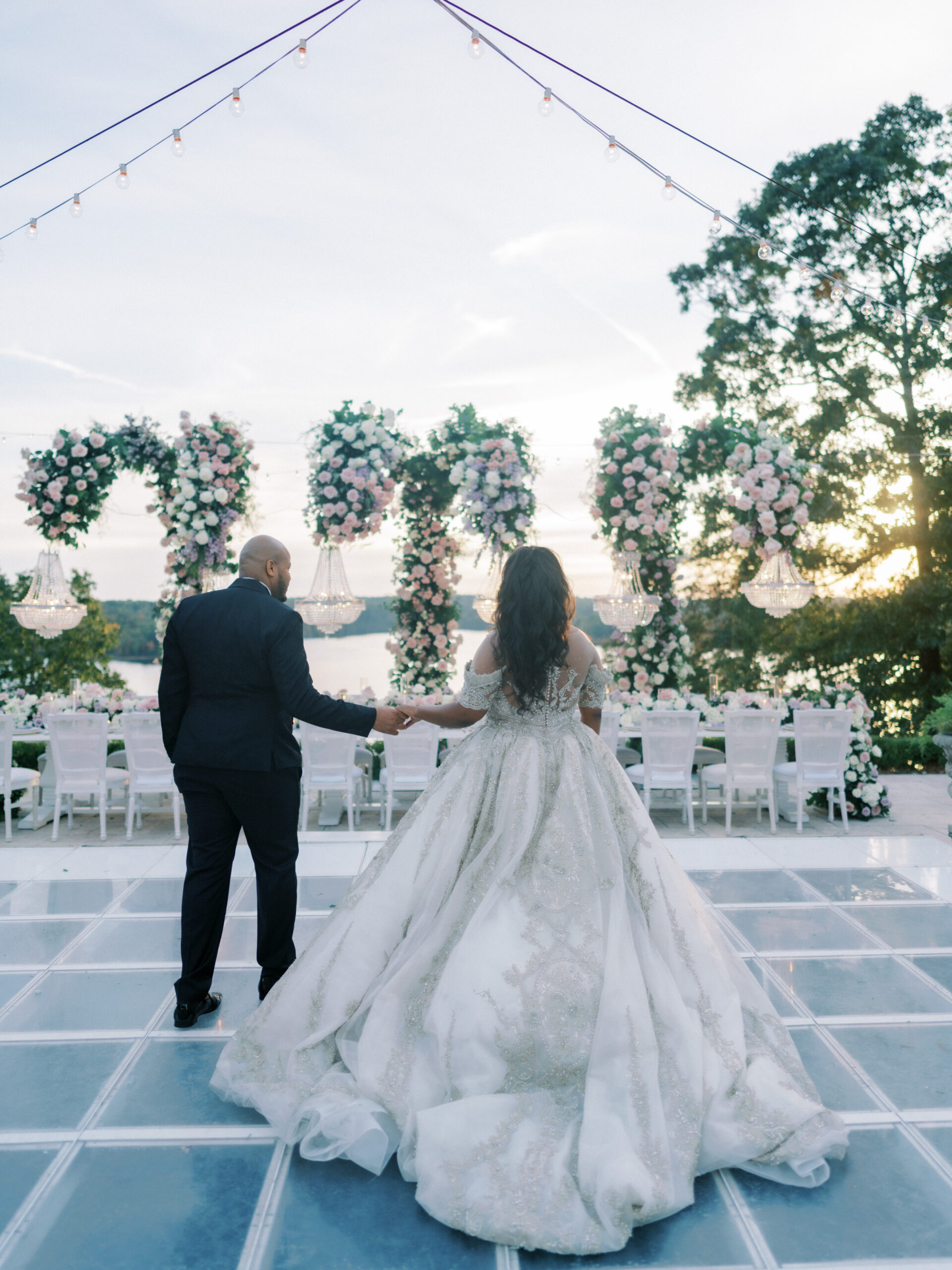 The bride and groom enter their wedding dance floor overlooking Lake Tuscaloosa.