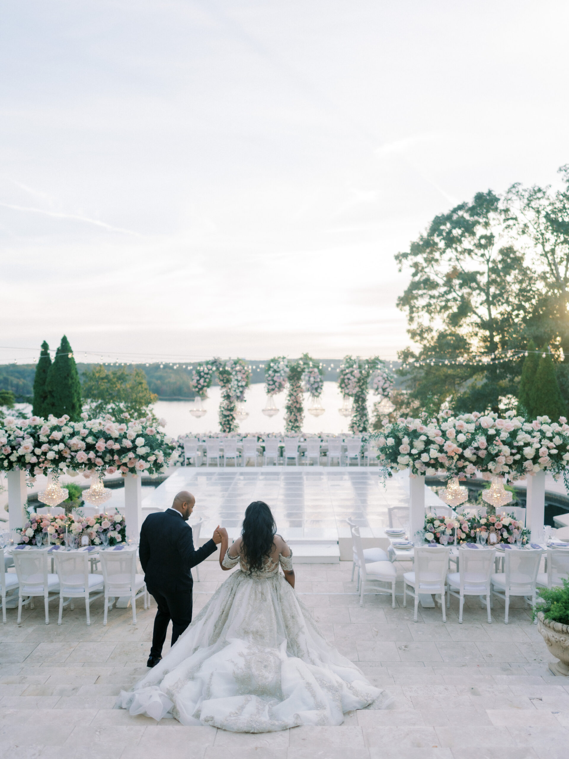 The bride and groom enter their wedding reception overlooking Lake Tuscaloosa in Alabama.