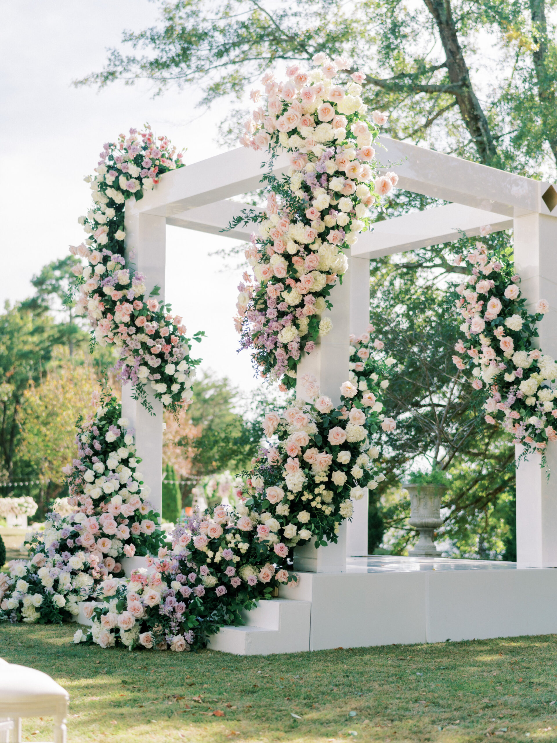 The wedding ceremony is decorated with many flowers.