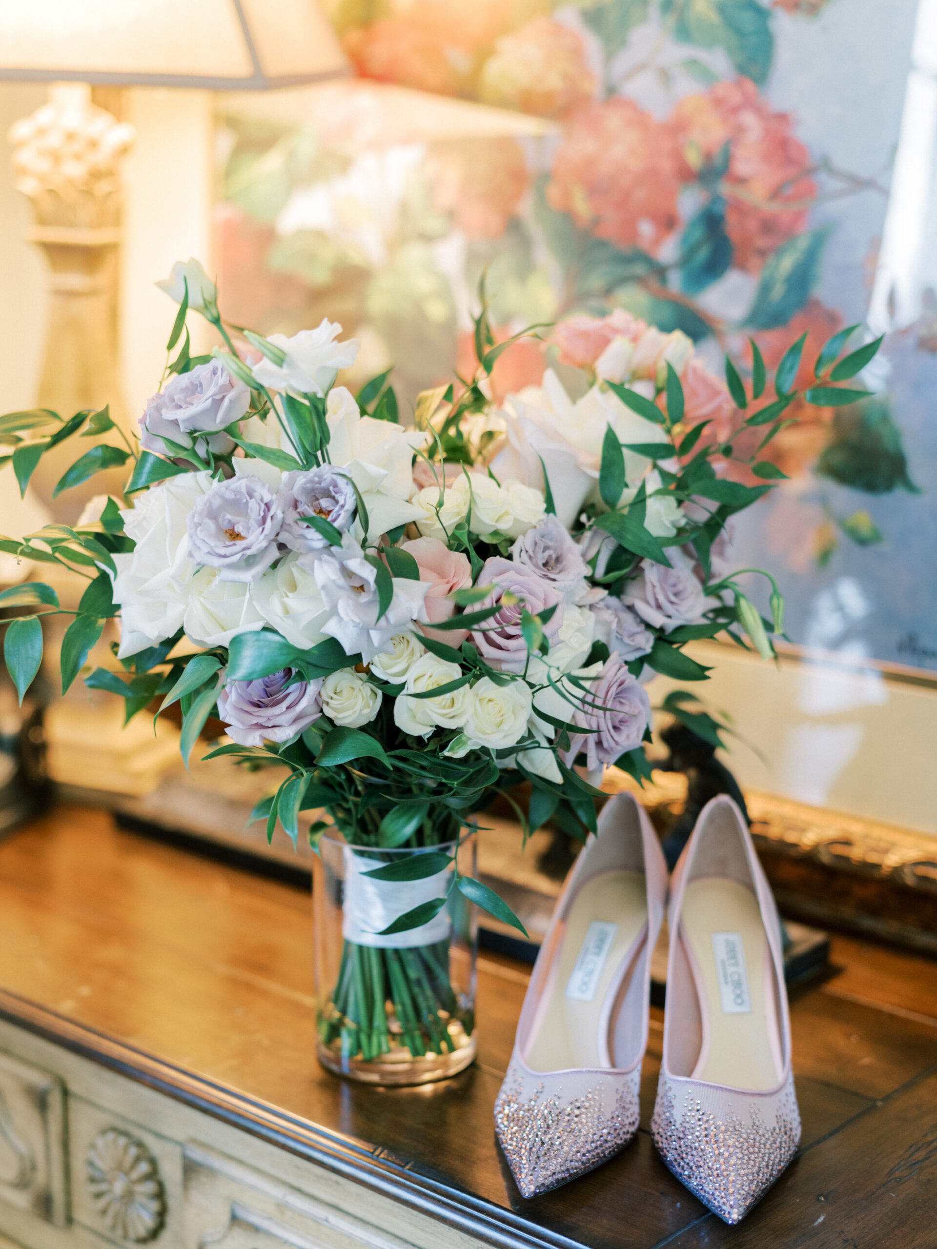 The bride's lilac shoes are photographed with the wedding bouquet.