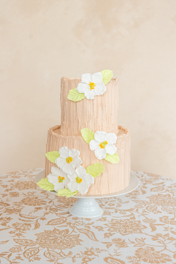 A cake from Olexa's Cafe is is decorated in flowers and buttercream for an Alabama wedding.