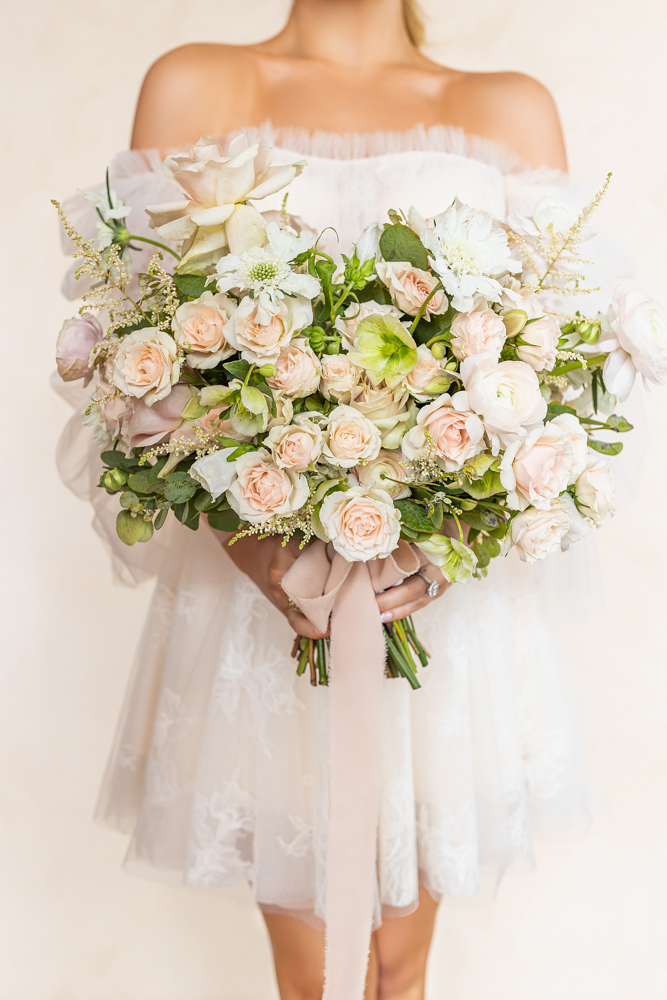 A bride holds a large bouquet by CeCe Designs for a wedding in Birmingham, Alabama.