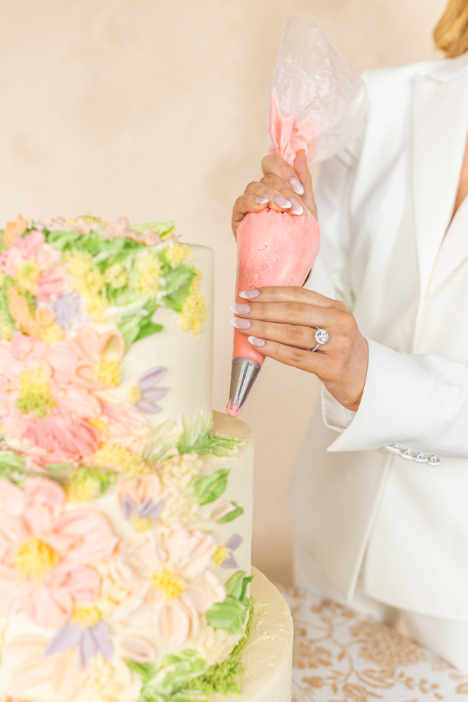 A bride helps decorate her wedding cake from Olexa's Cafe in Mountain Brook, Alabama.