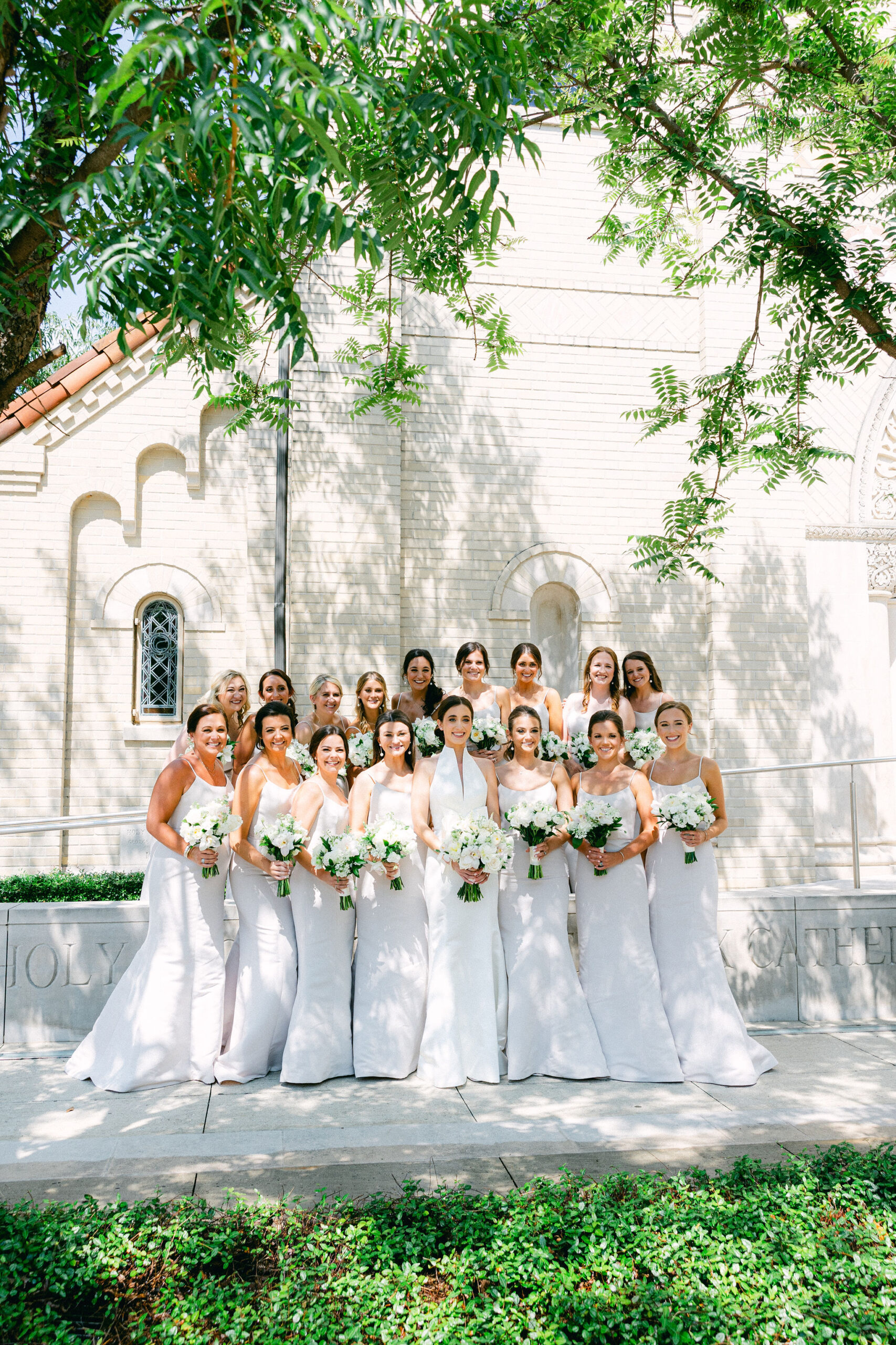 The bridal party stands together outside the church before the wedding ceremony in Alabama.