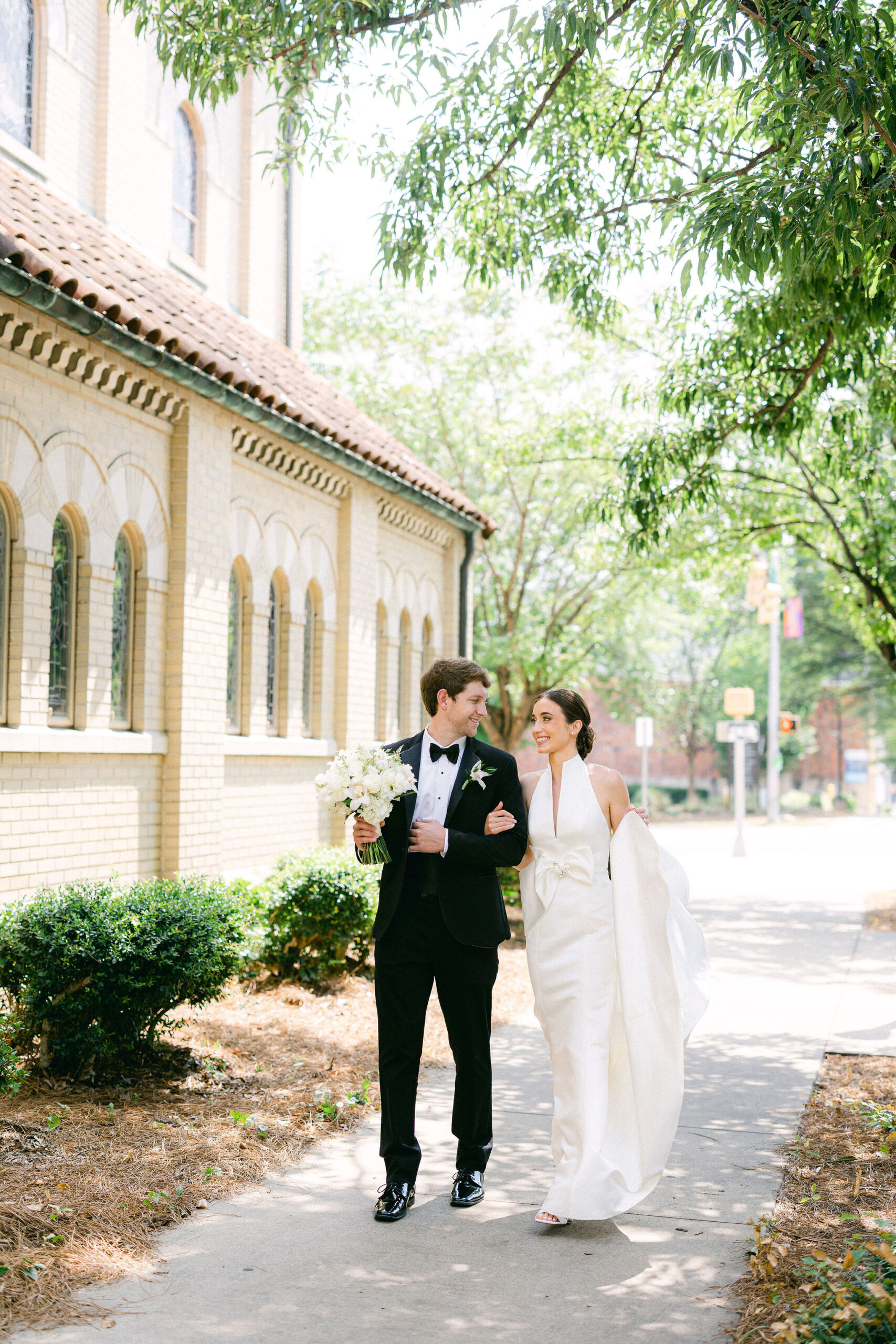 The bride and groom walk together to their ceremony in downtown Birmingham.