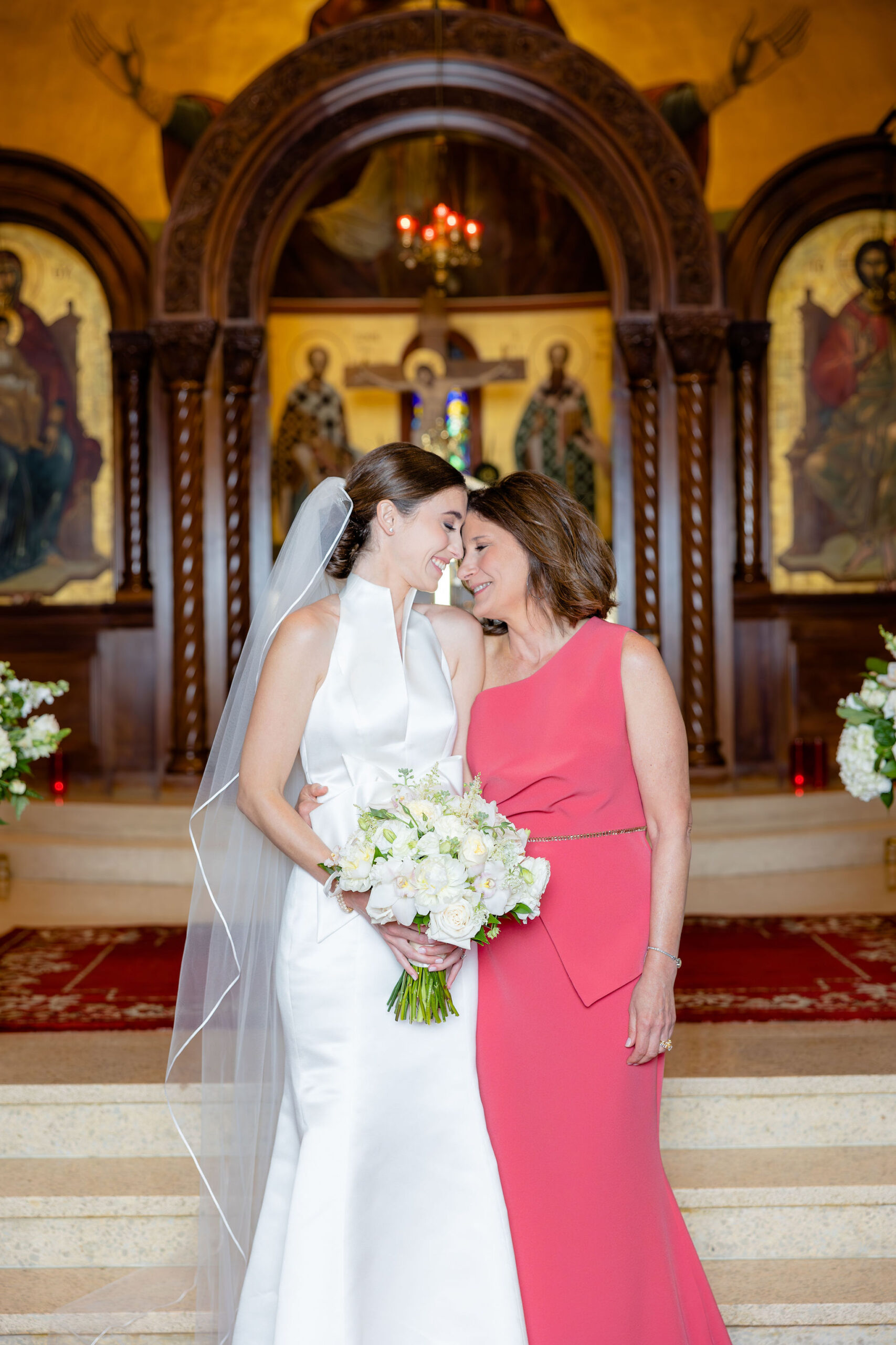 The bride and her mother embrace at the wedding ceremony in Alabama.