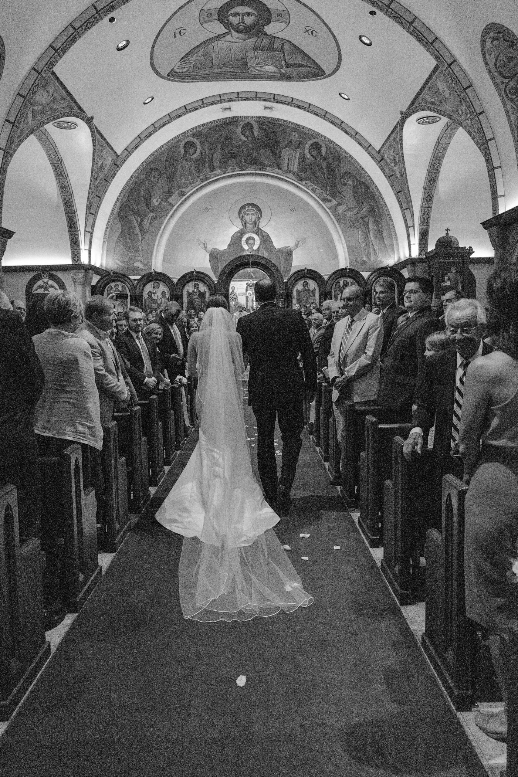 The father of the bride walks his daughter down the aisle for the wedding in Alabama.