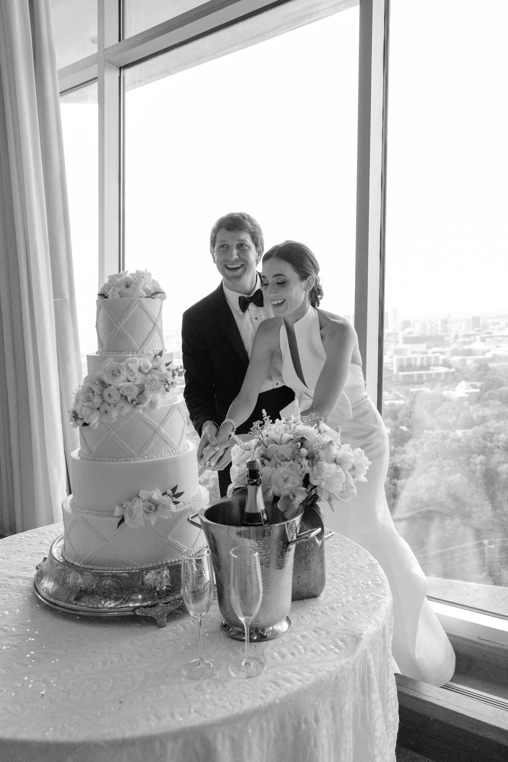 The bride and groom cut the cake together at The Club.