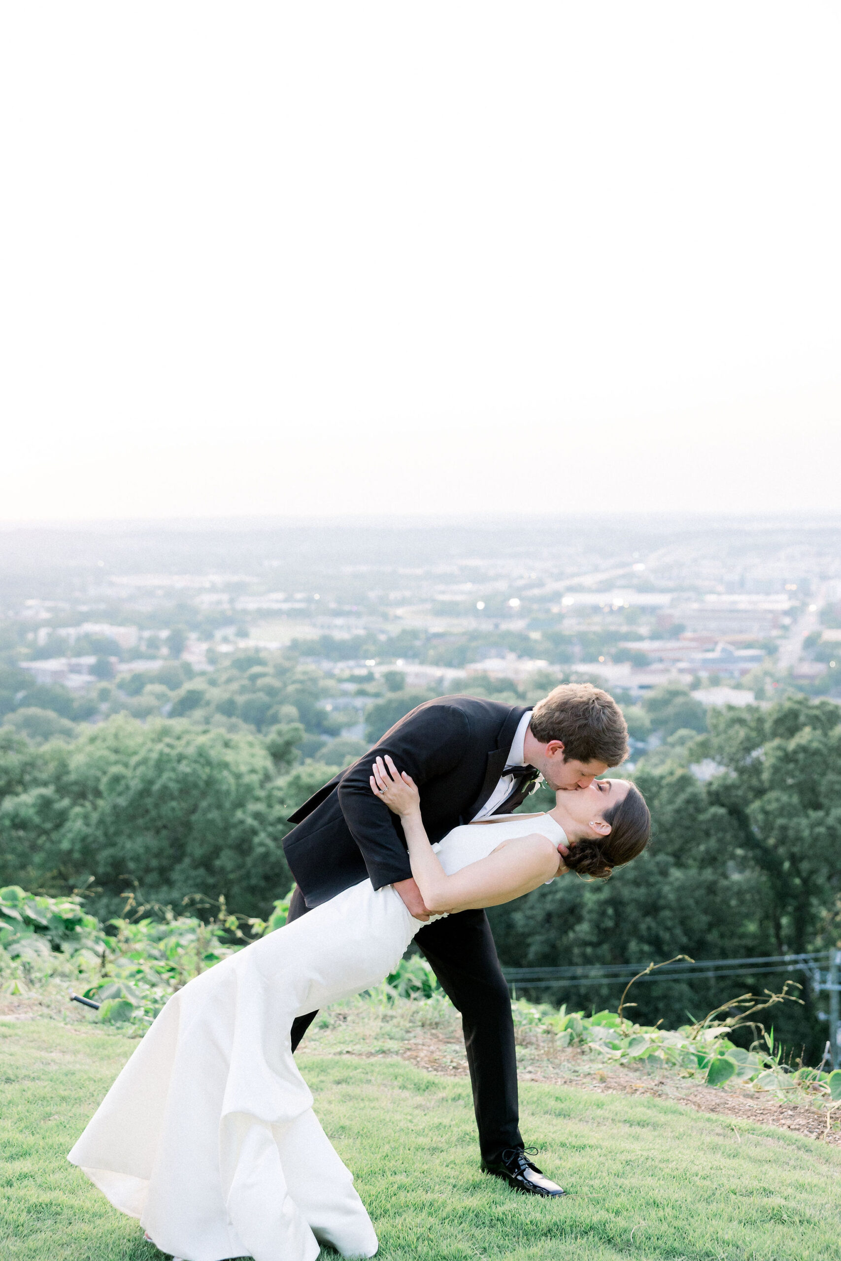 The bride and groom kiss overlooking downtown Birmingham, Alabama.