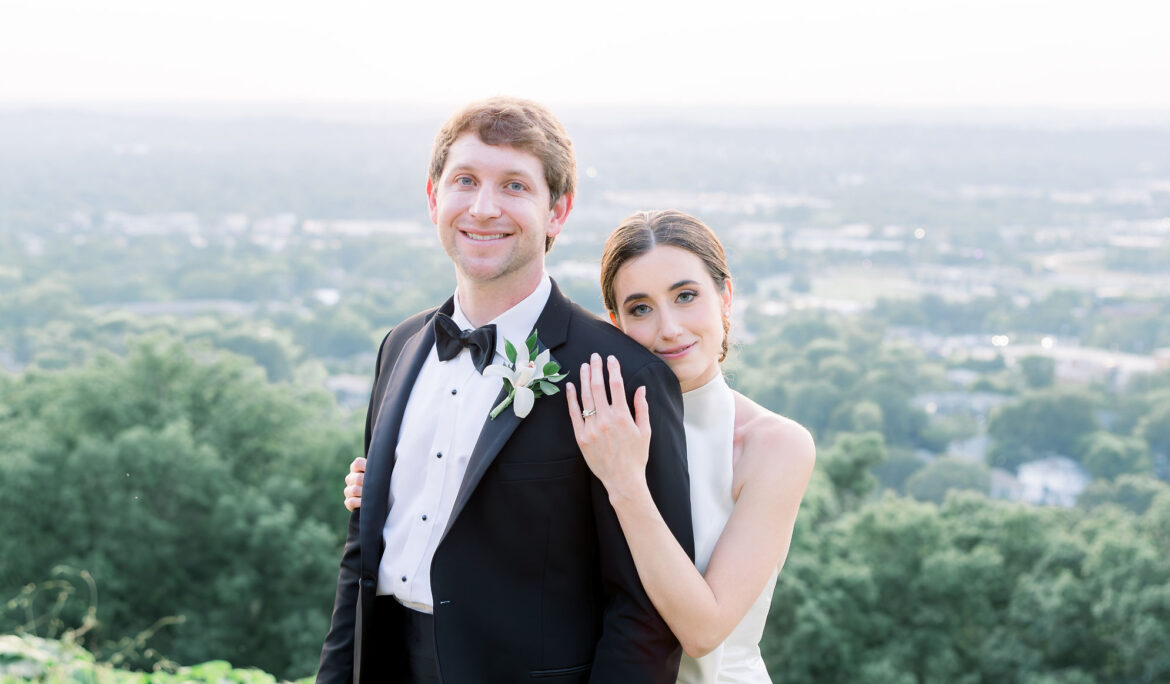 The bride and groom embrace overlooking Birmingham, Alabama.