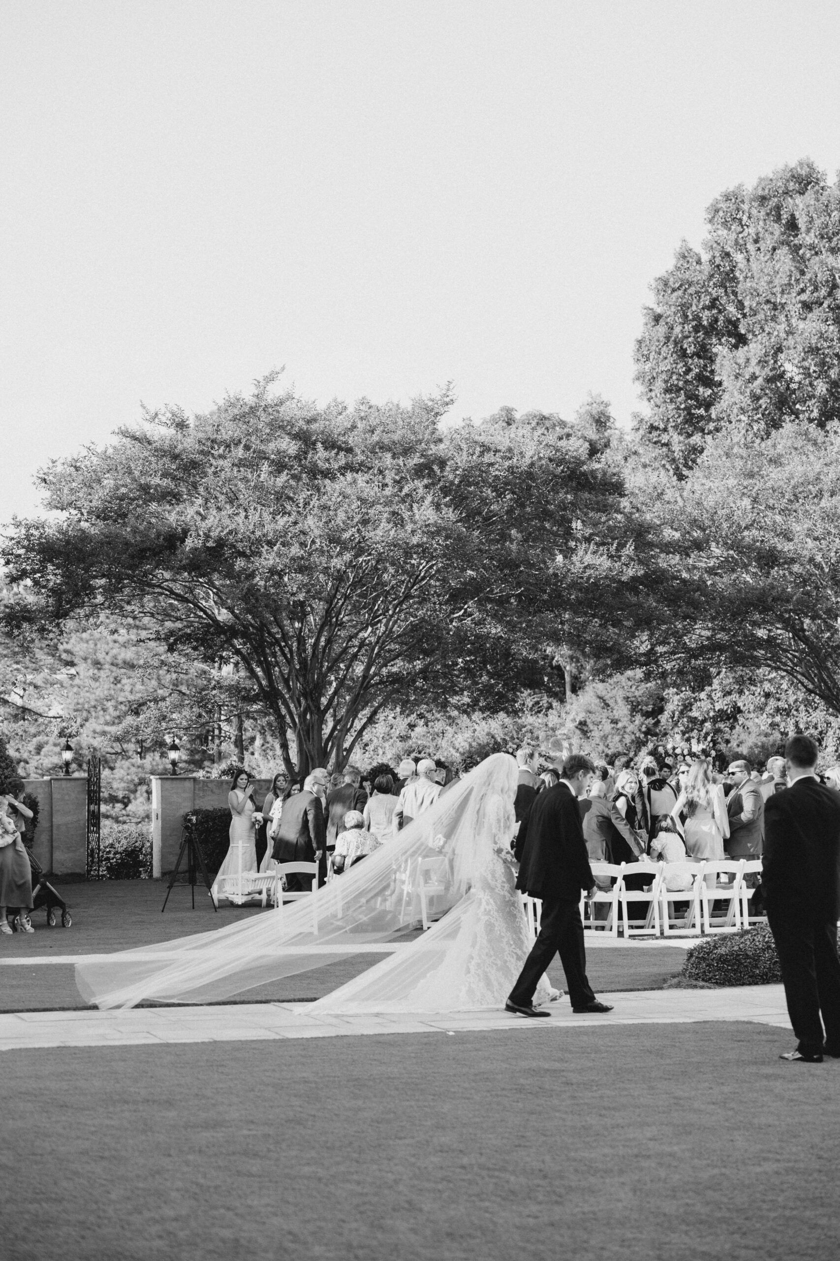 The father of the bride walks his daughter down the aisle in Auburn, Alabama.