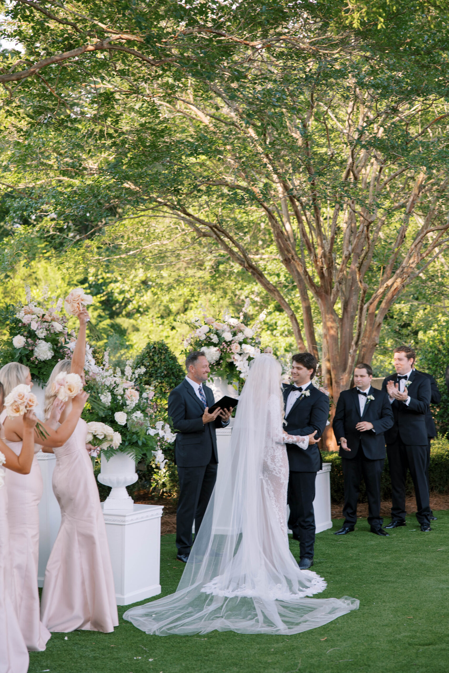 The bride and groom get married in an outdoor ceremony in Auburn.