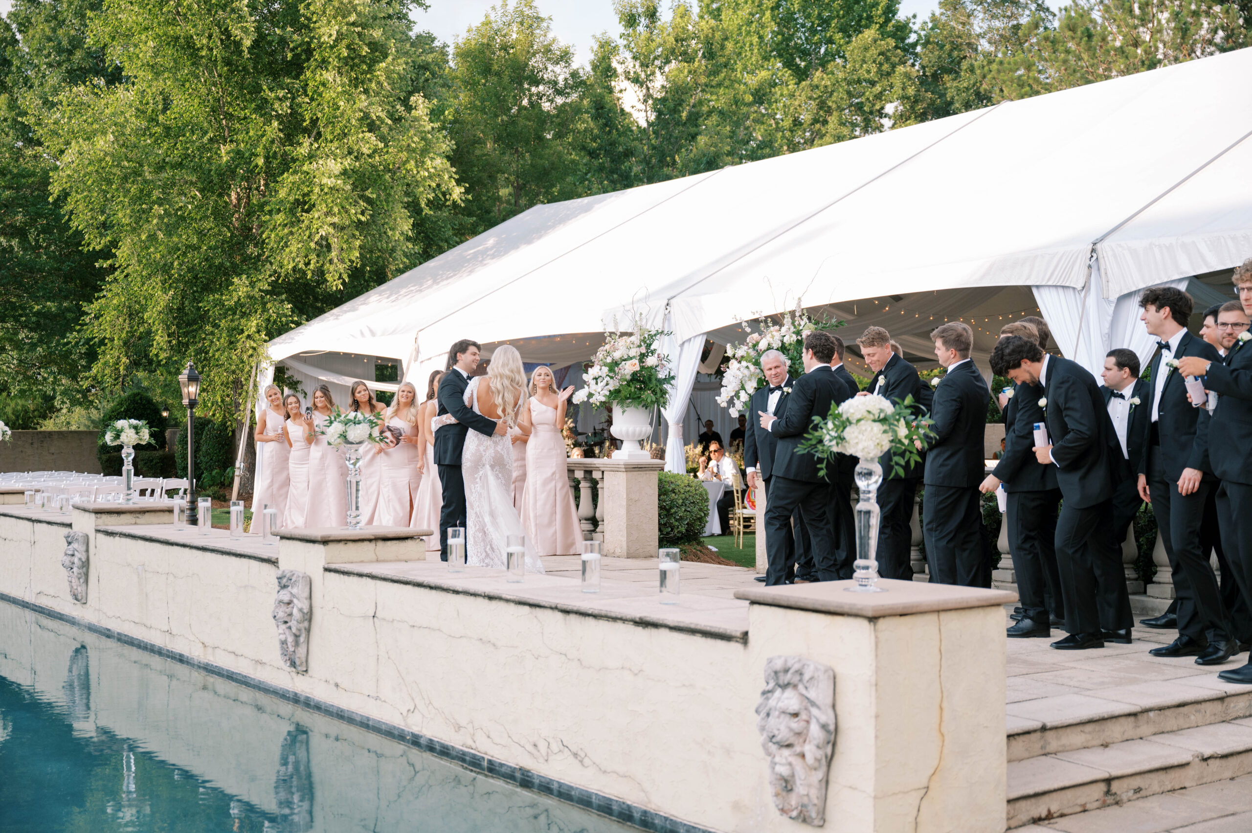 The bride and groom stand together during their tented wedding reception at Fountainview Mansion.