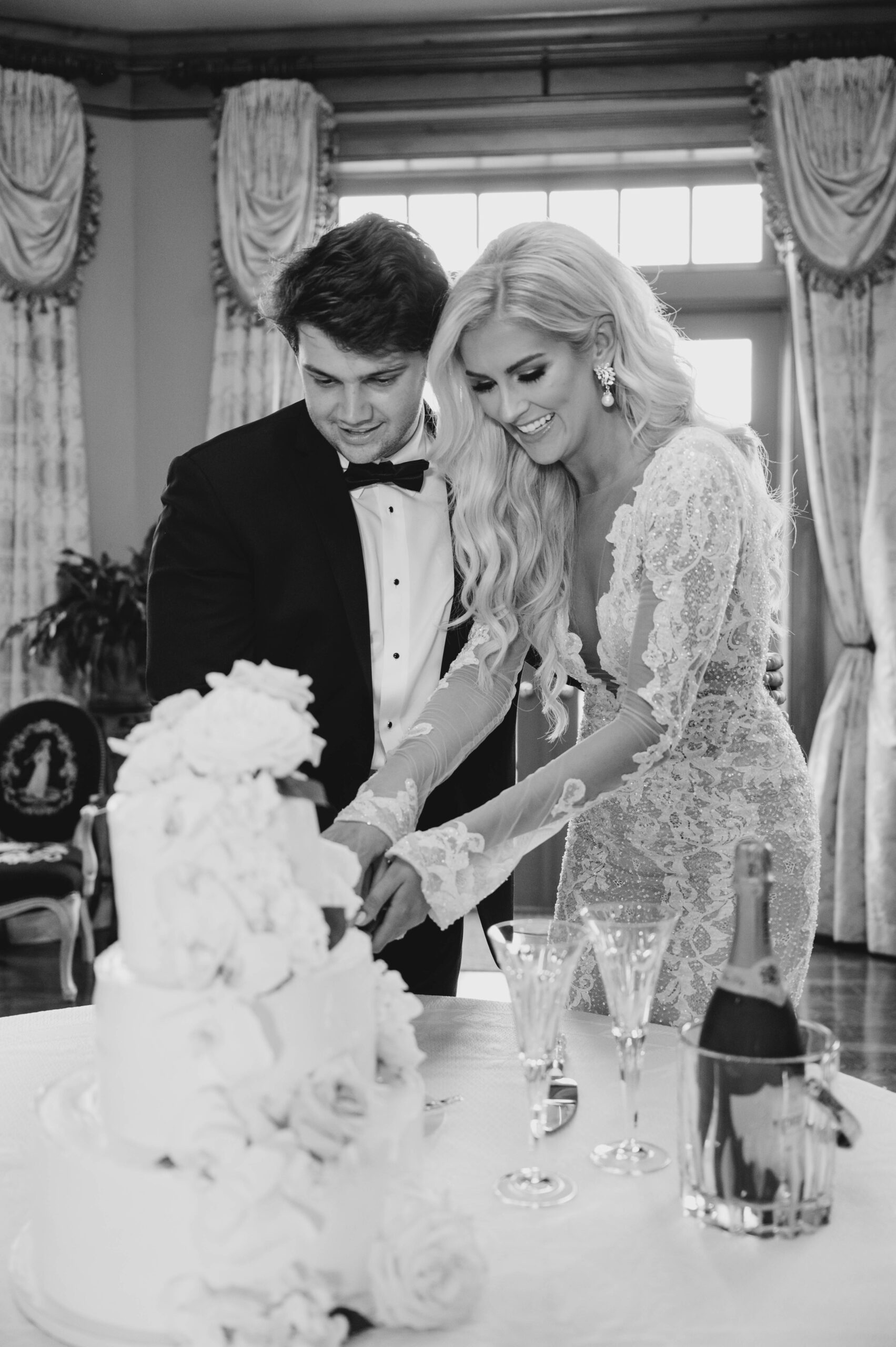 The bride and groom cut the cake at their Auburn wedding reception.