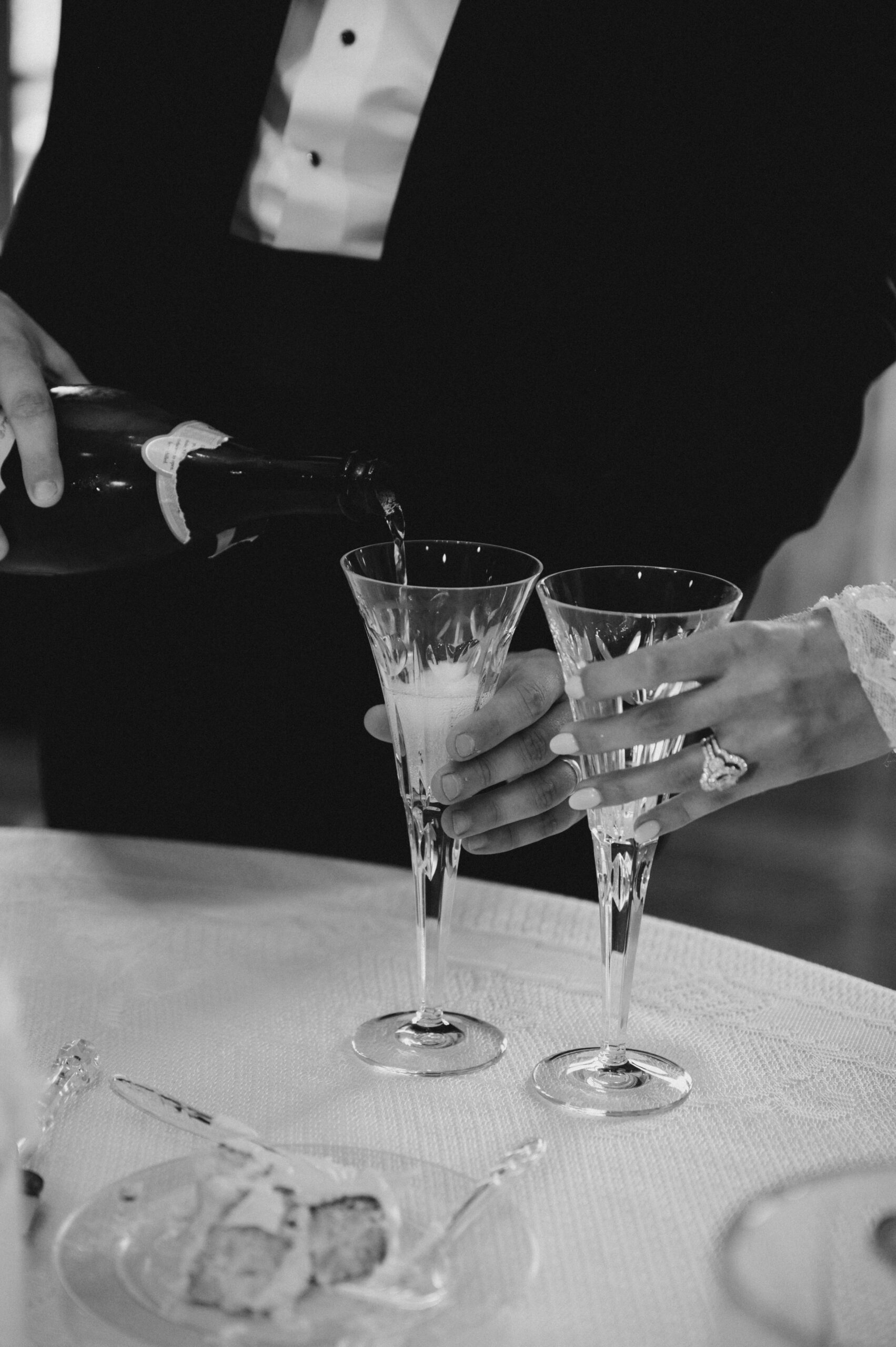 The bride and groom share a glass of champagne during their Southern wedding.