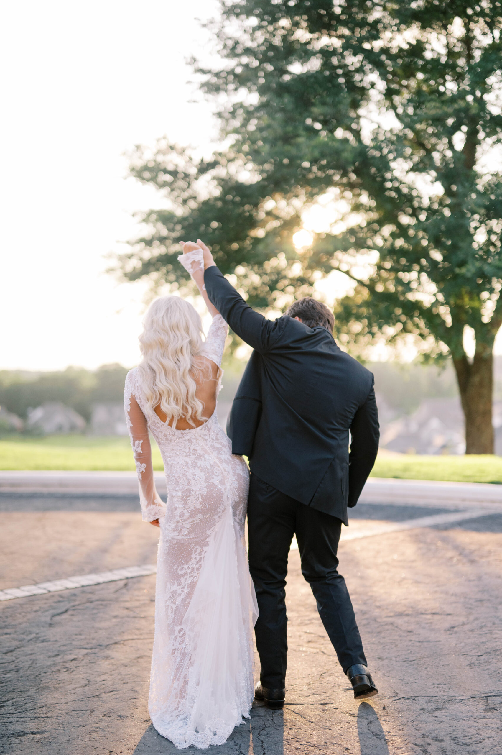 The bride and room hold hands.