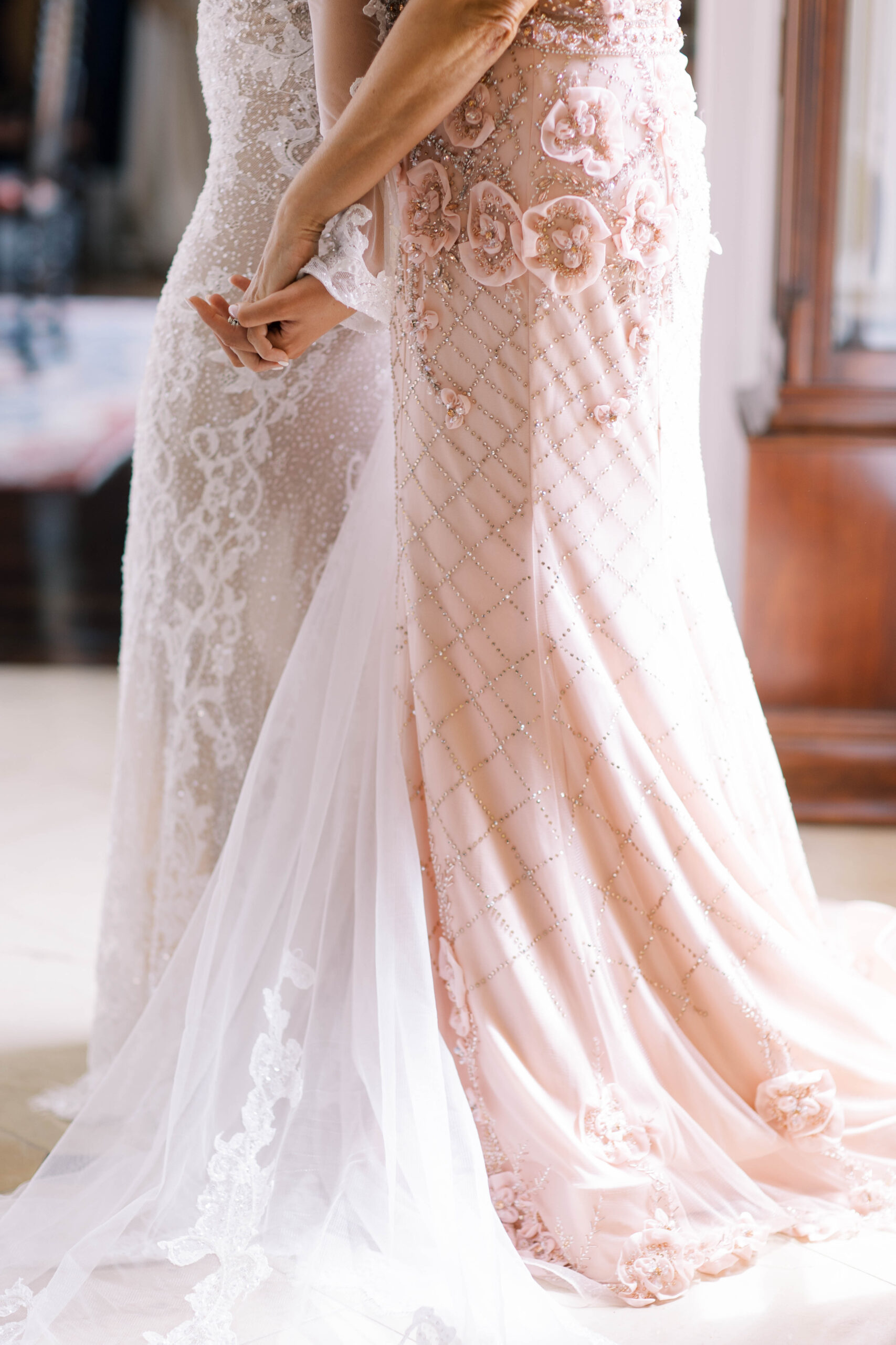 The mother and bride hold hands before the Southern wedding ceremony.