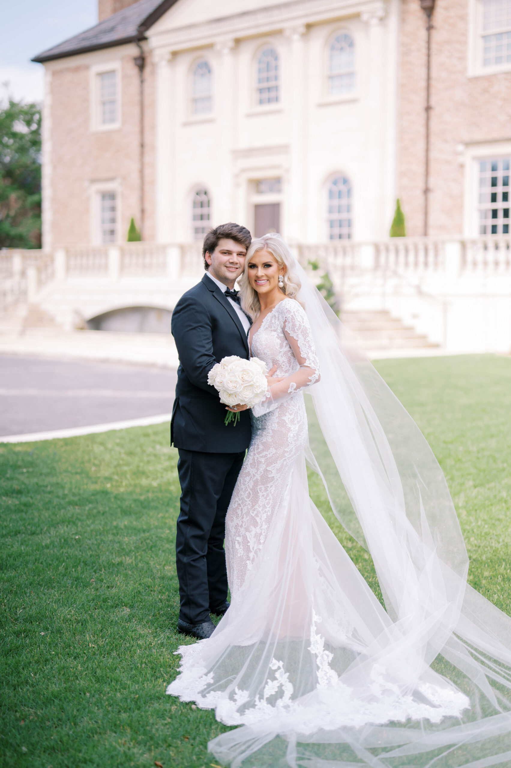 The bride and groom embrace outside of Fountainview Mansion in Auburn, Alabama.