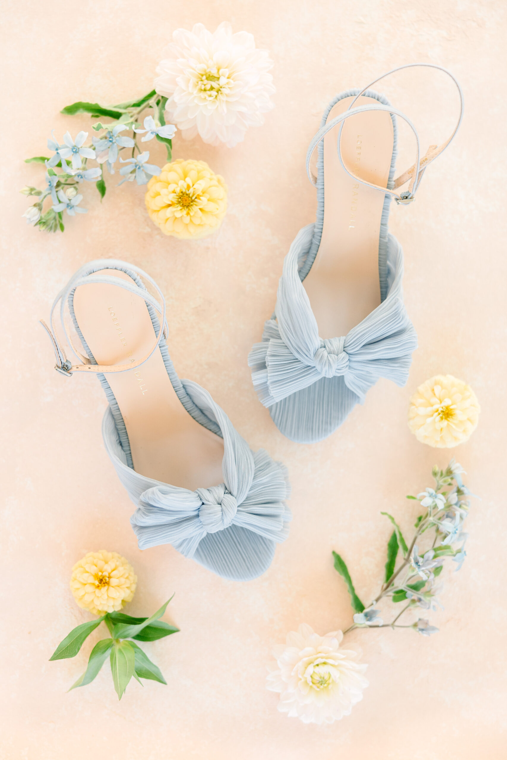 The blue bridal shoes are styled with flowers.