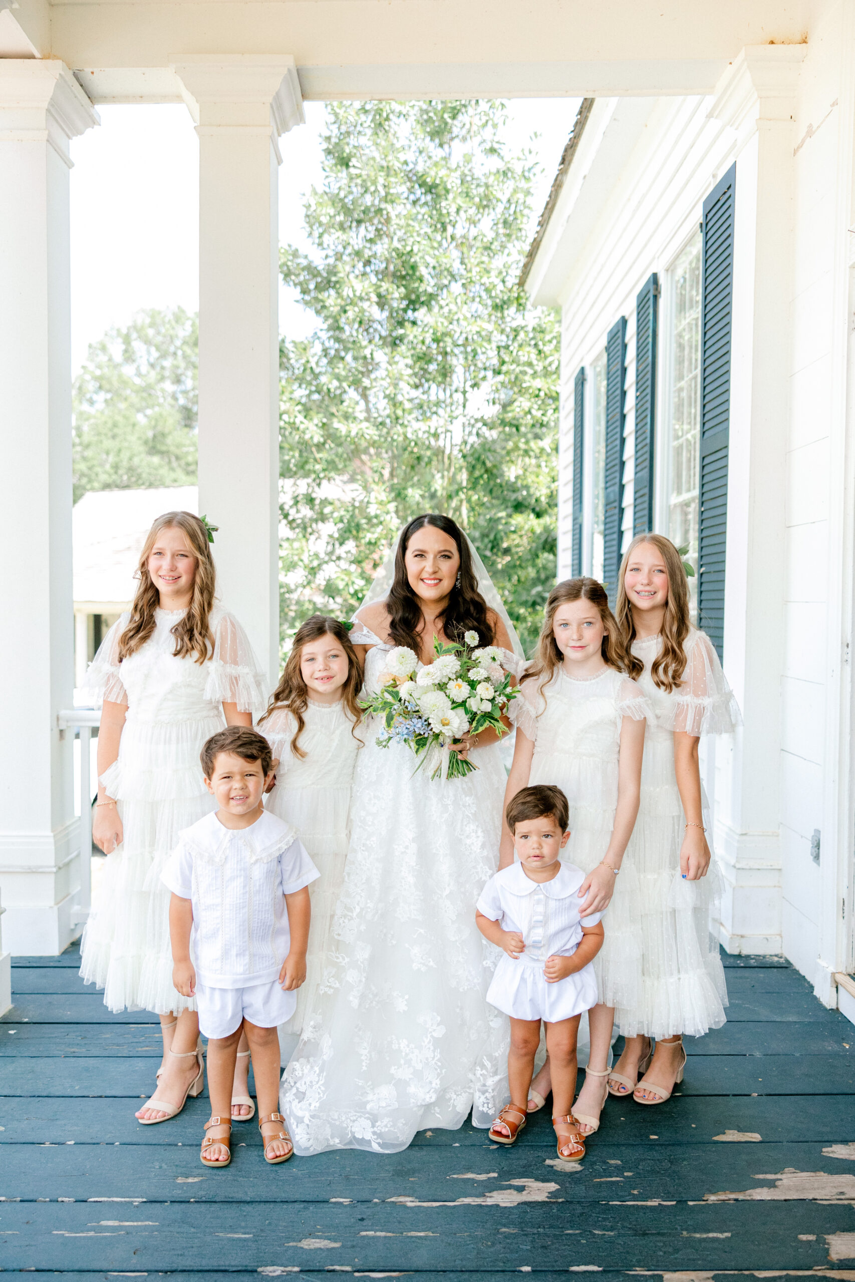 The bride poses with the children at the wedding in Alabama.