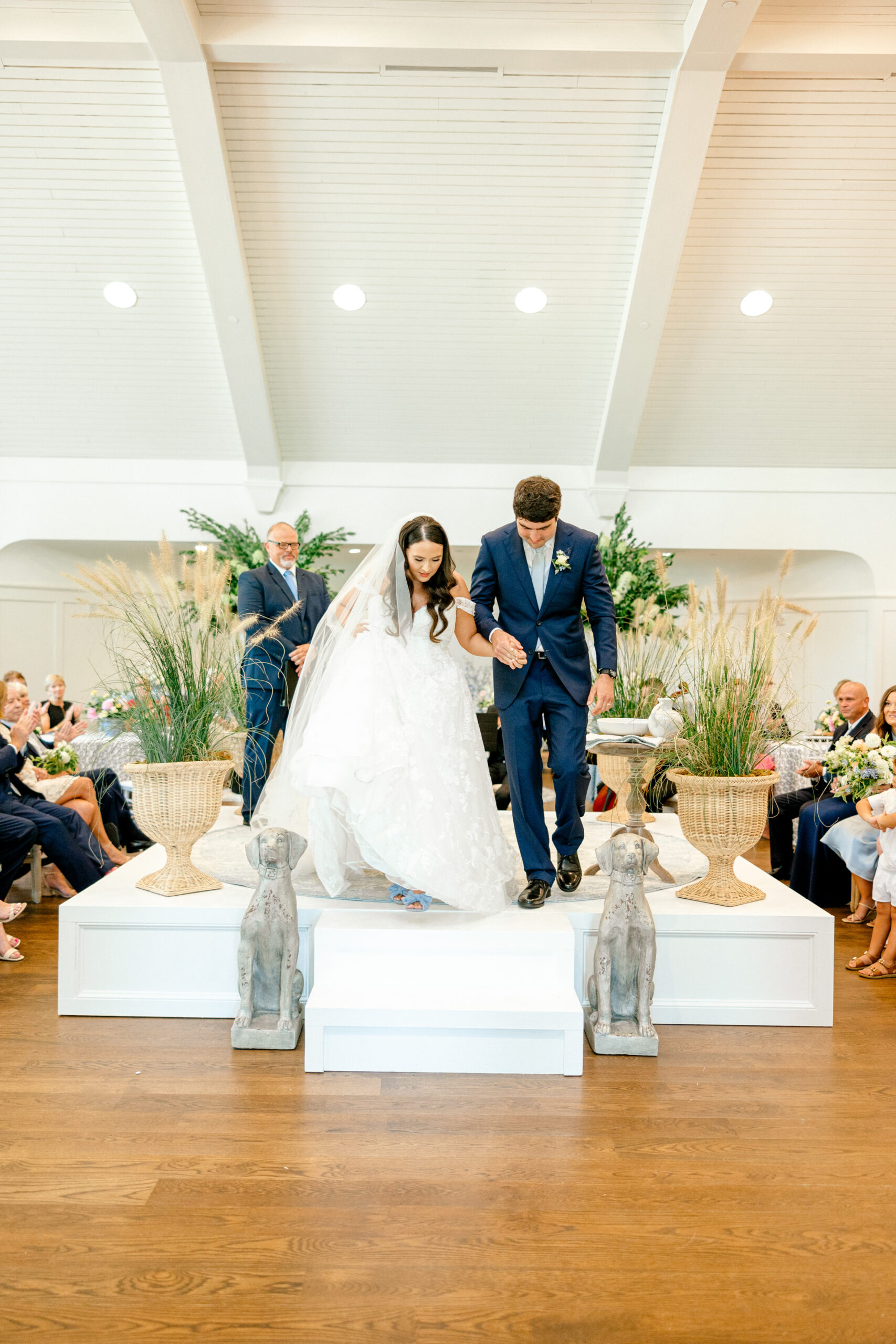 The bride and groom leave the wedding ceremony together at Pursell Farms.