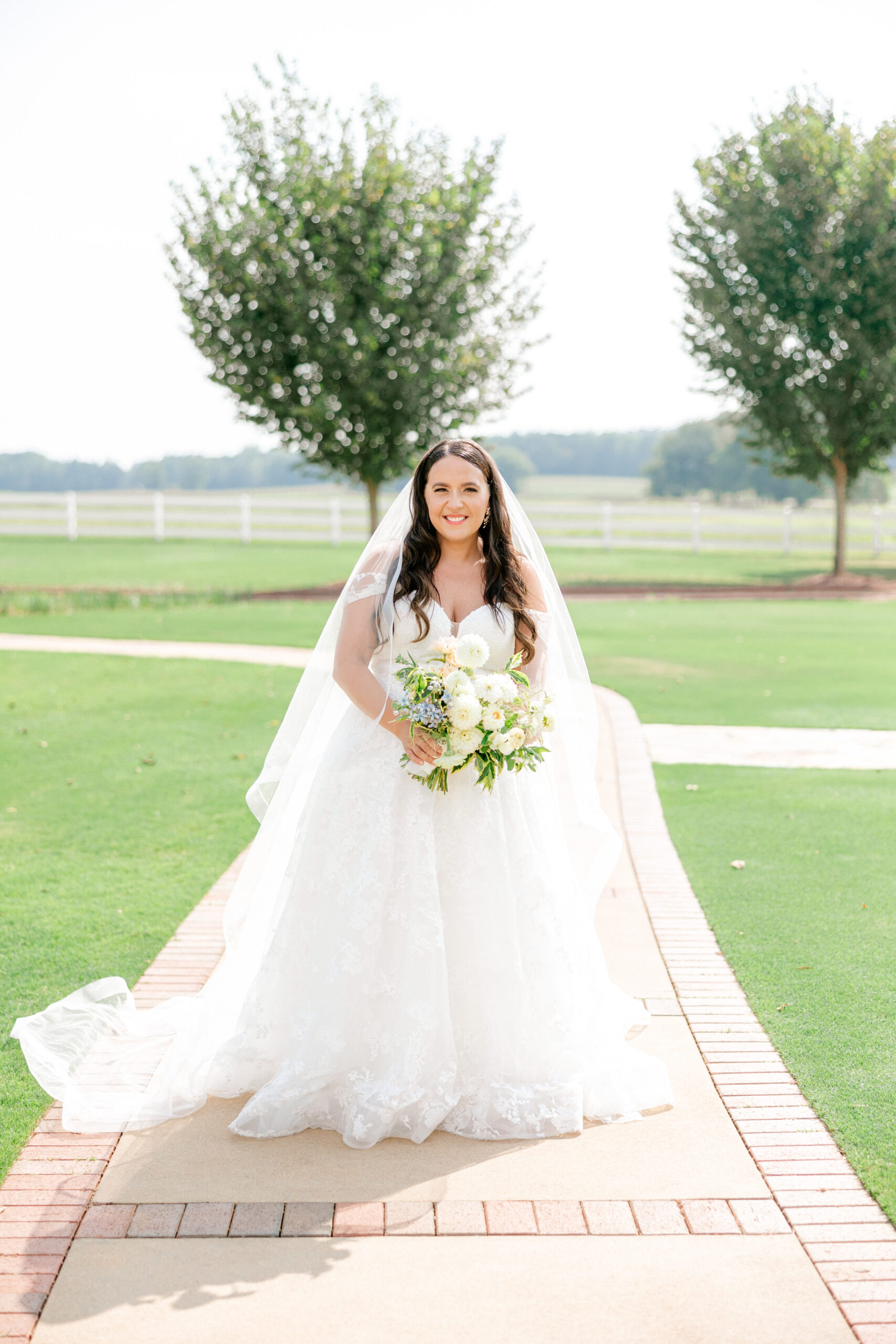 The bride poses with her bouquet at Pursell Farms.