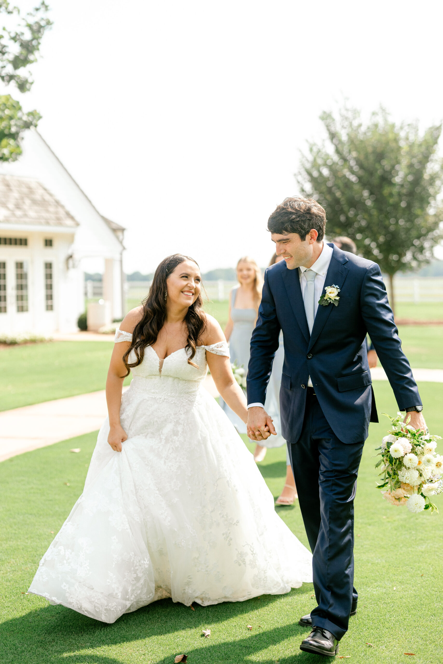 The bride and groom walk together on the grounds of Pursell Farms in Alabama.