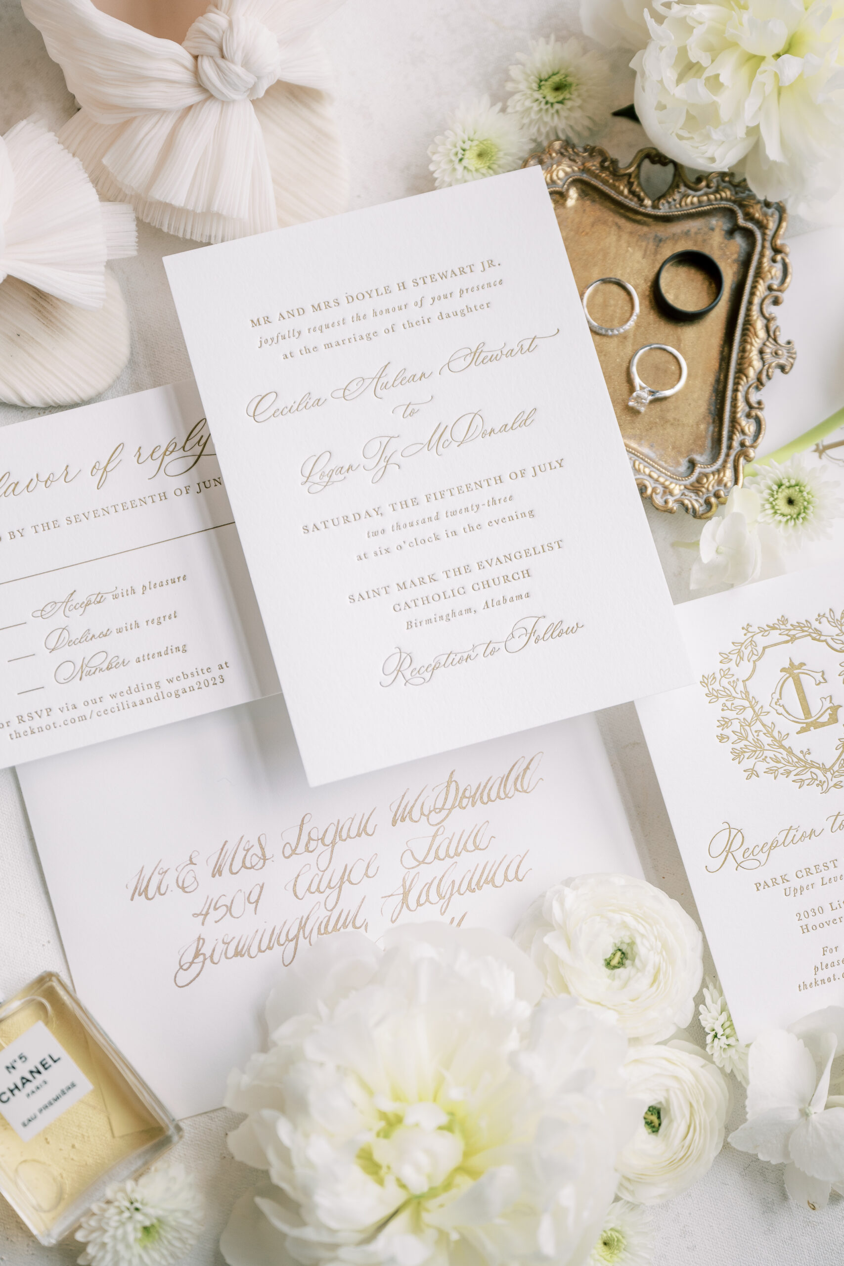 White wedding invitations are styled with the shoes and jewelry.