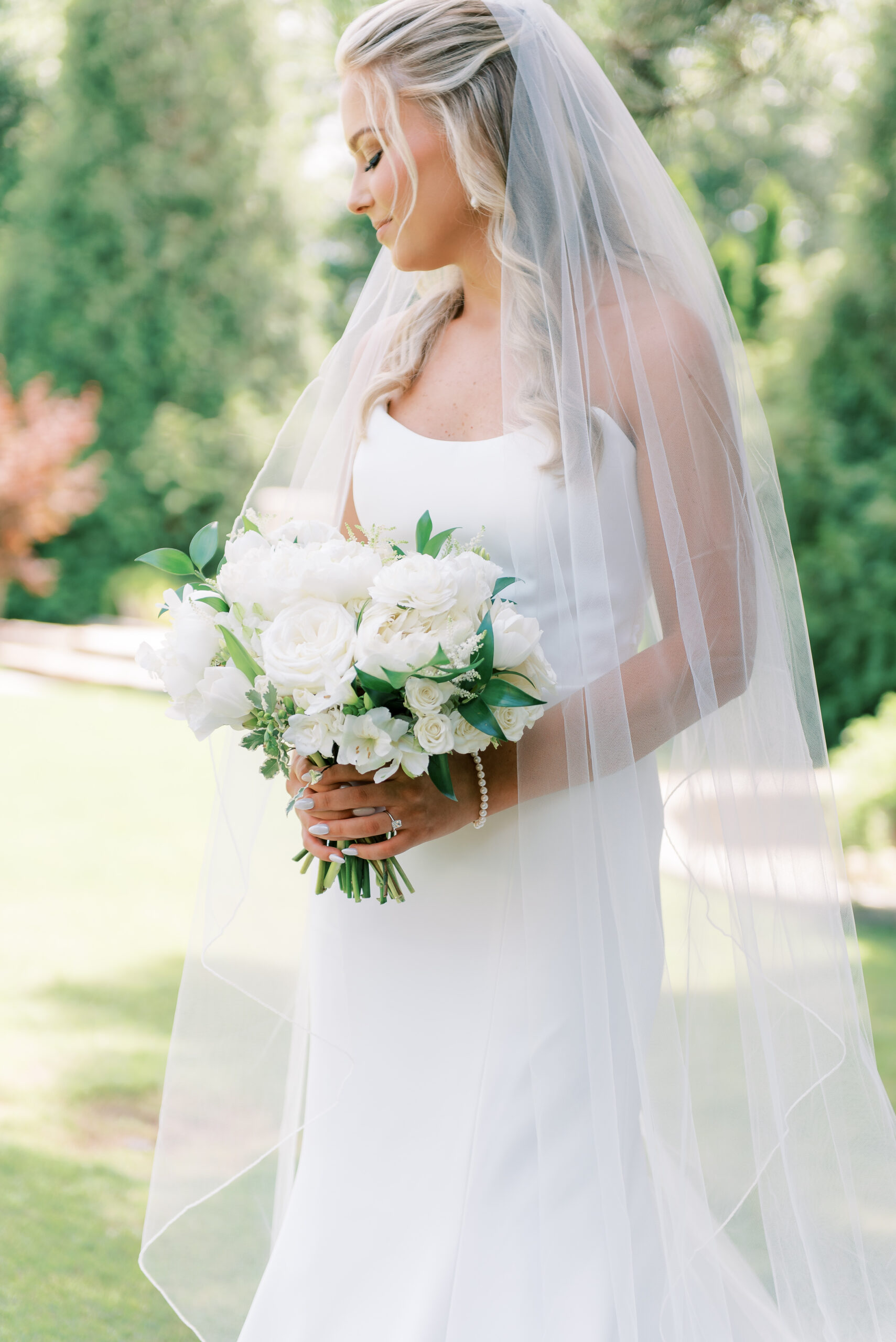 The bride holds her white bouquet on her Alabama wedding day.