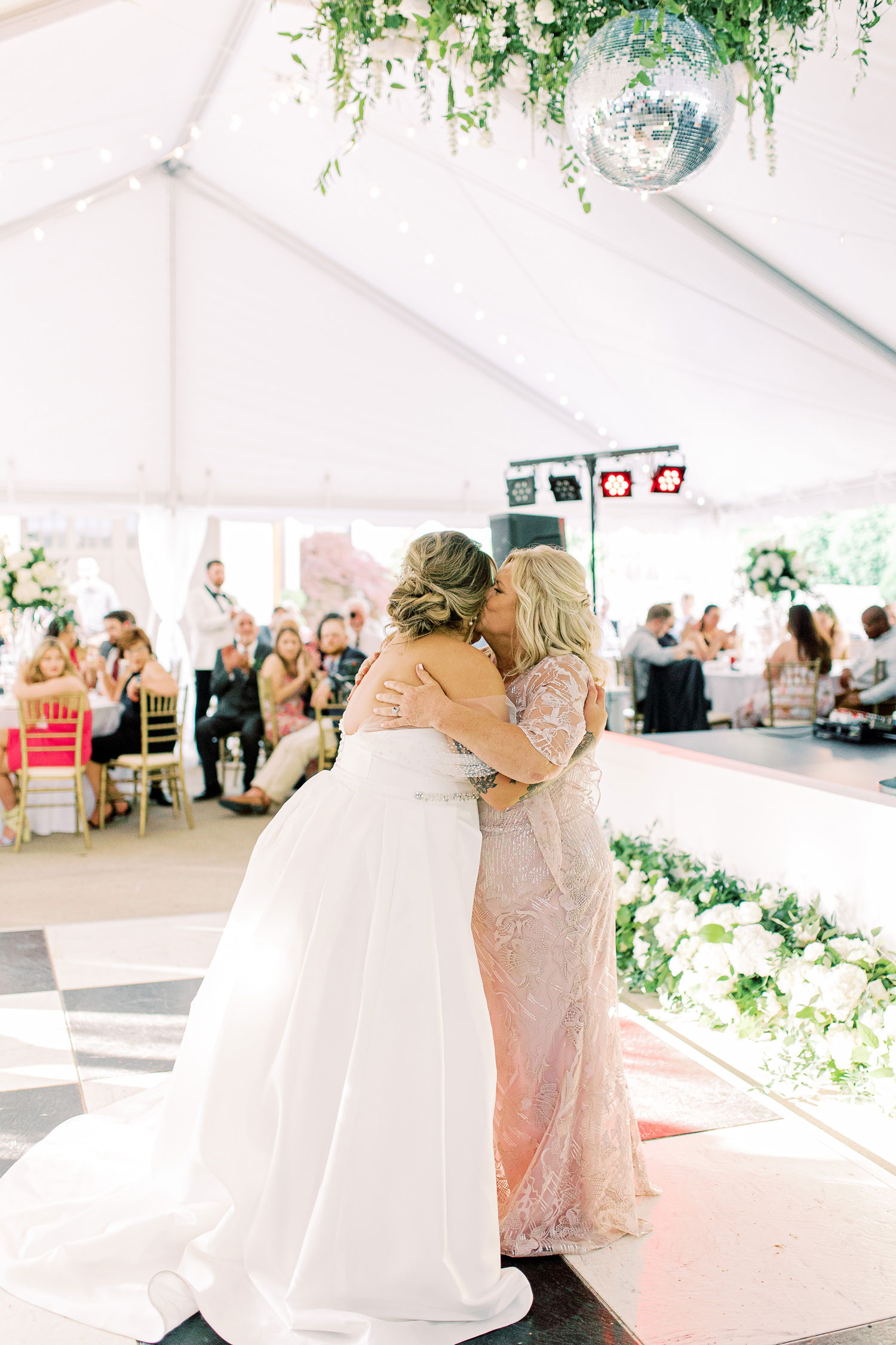 The mother of the bride hugs her daughter on the dance floor at a wedding in Alabama.