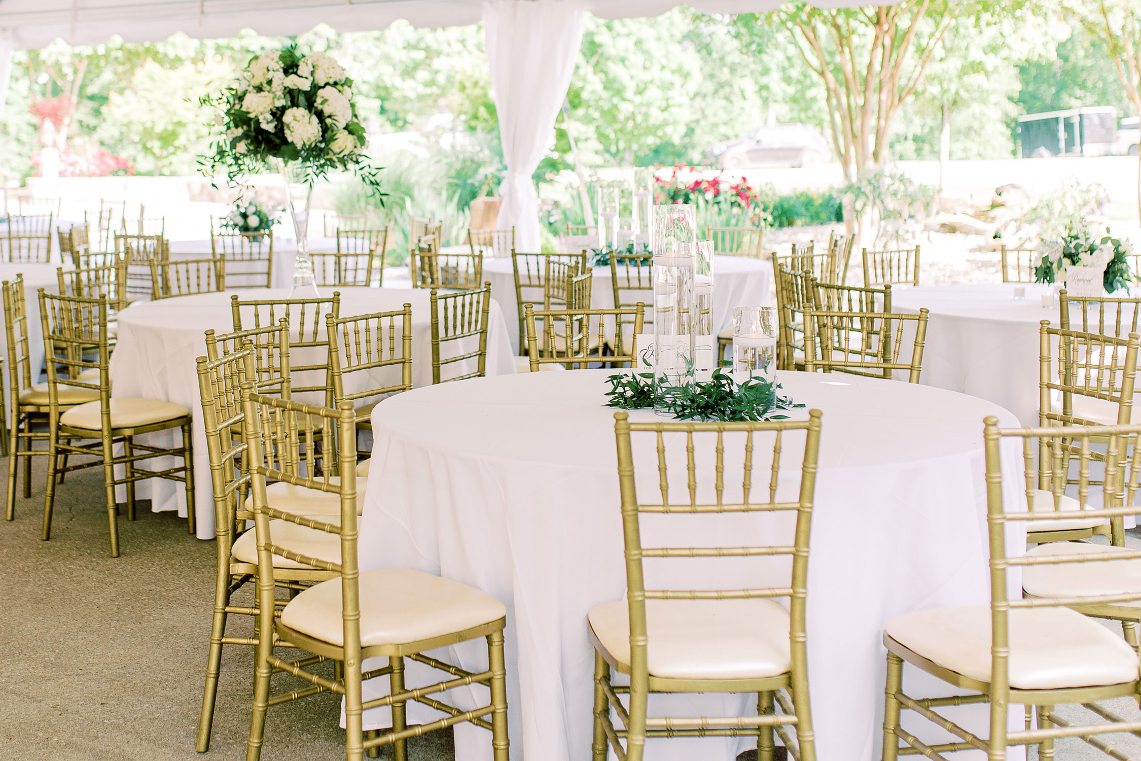 Wedding reception tables are set with candles and white flowers in Florence, Alabama.