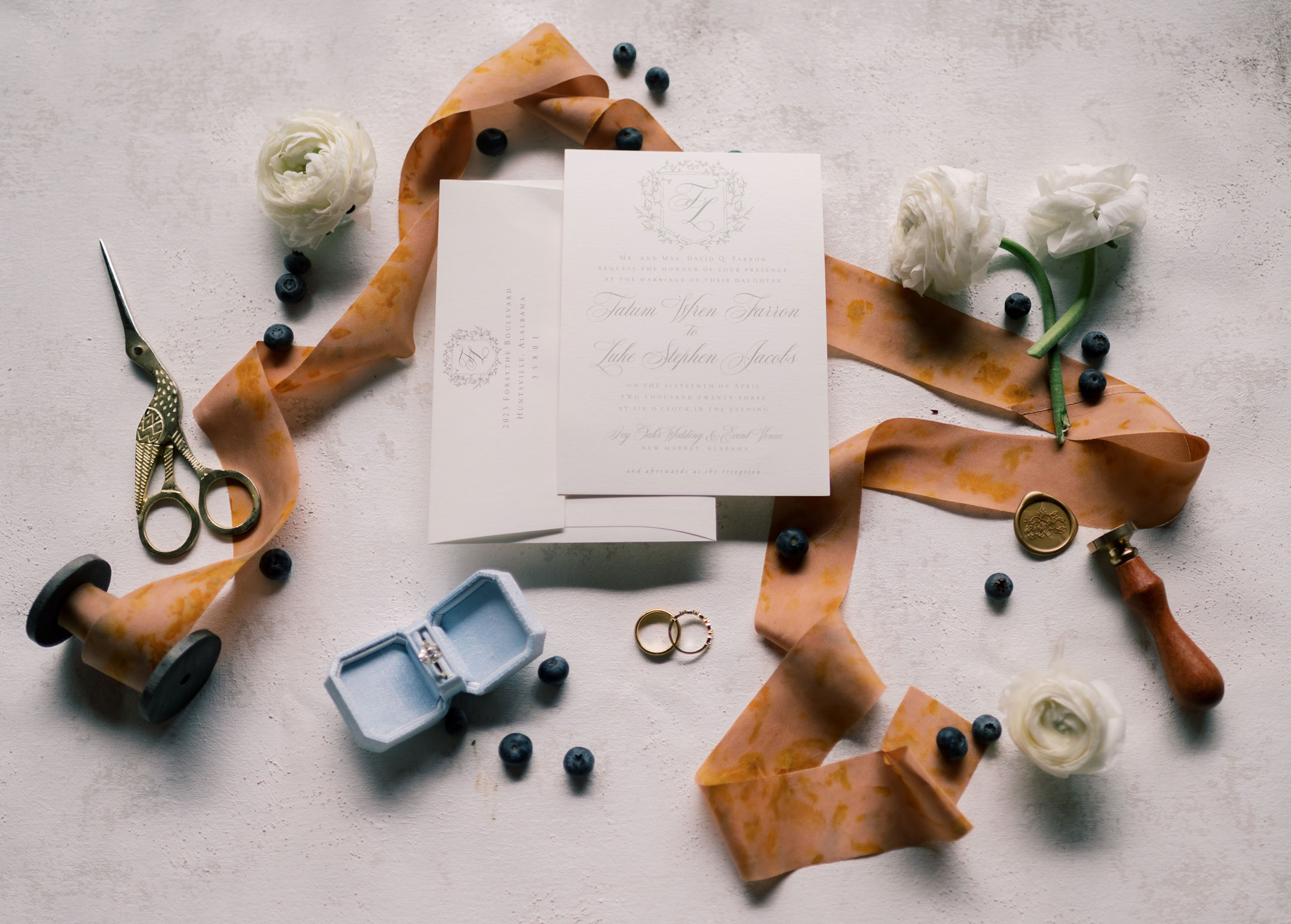 Wedding invitations are styled with ribbon and the wedding rings.